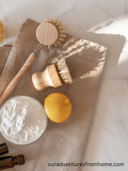 All natural cleaning supplies lying on dish towel on kitchen counter for a detox home