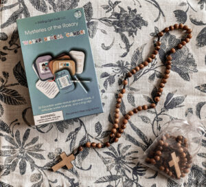 Rosary and rosary cards on table for kids easter basket
