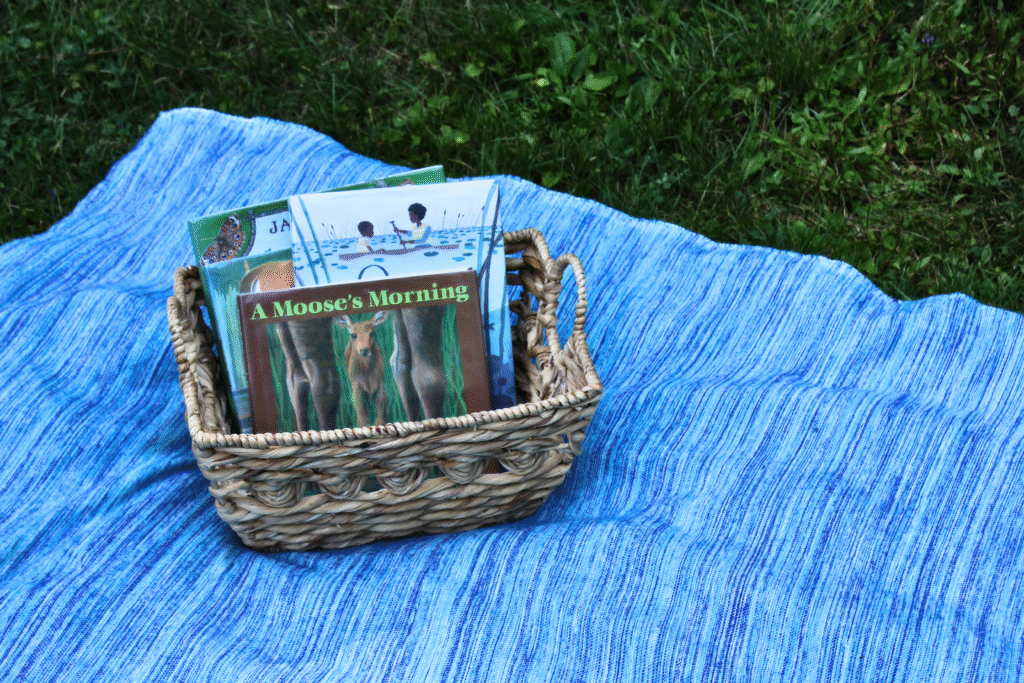 Inviting Library book basket placed on a blanket outside in the grass