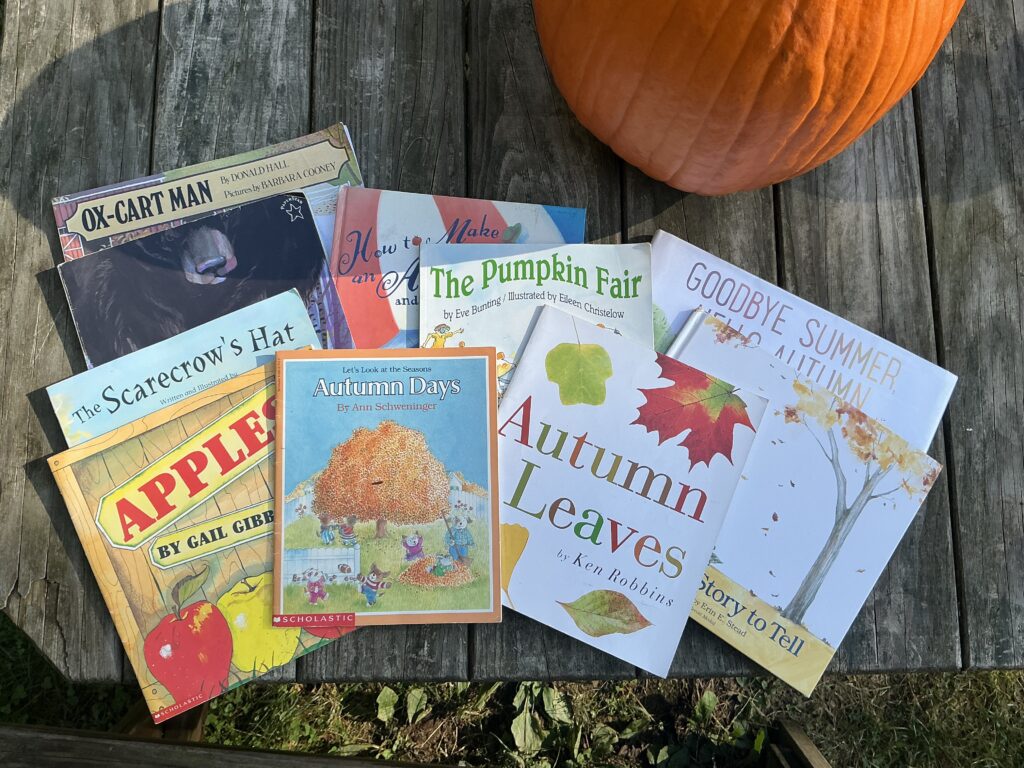 Spread of autumn picture books laid on a picnic table