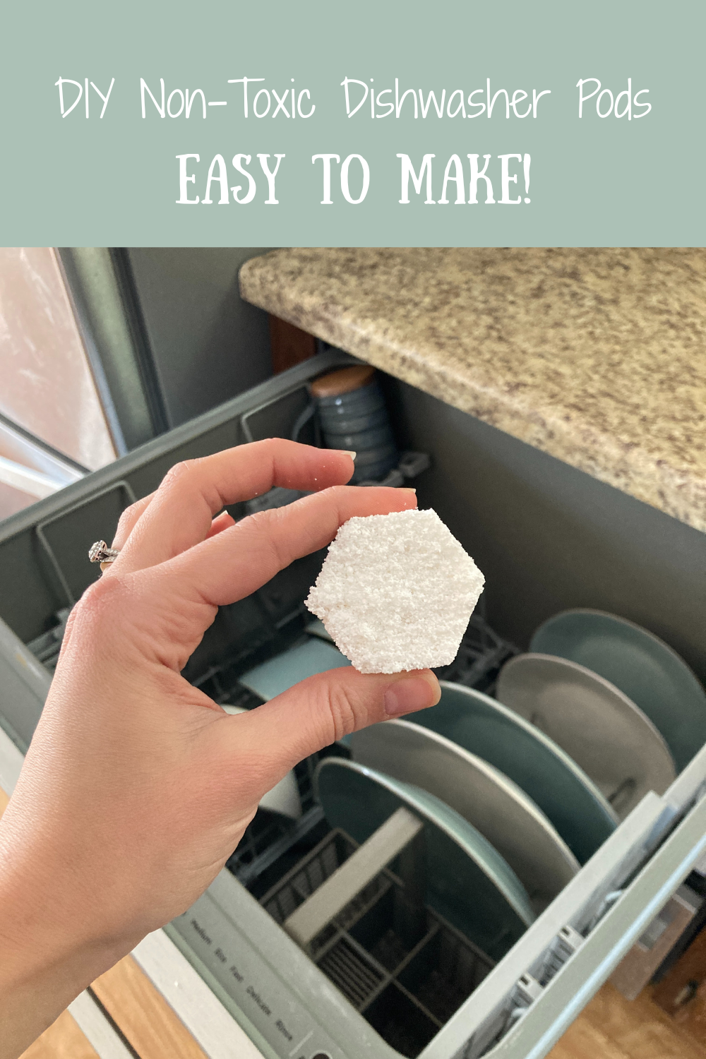 Hand holding a dishwasher pod above an open dishwasher
