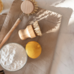 All natural cleaning supplies lying on dish towel on kitchen counter