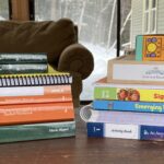 Homeschool curriculum books stacked up on table