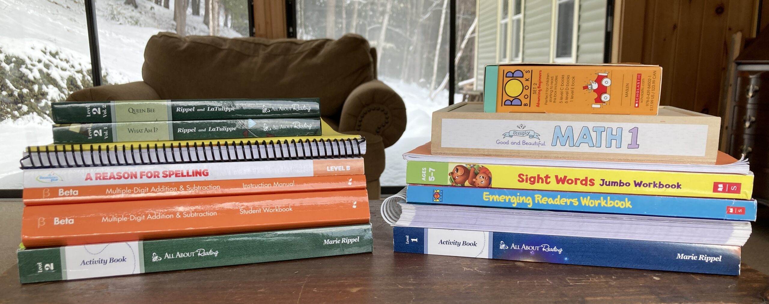 Homeschool curriculum books stacked up on table